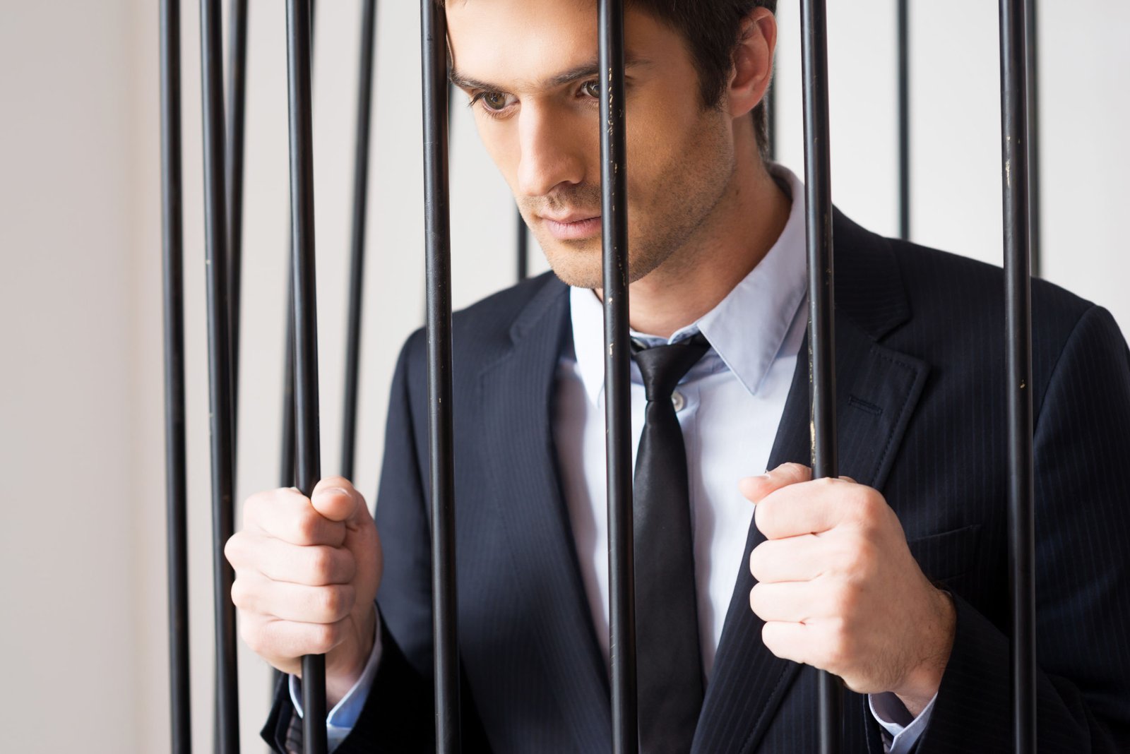 A person waiting for appearance bond behind the jail bars